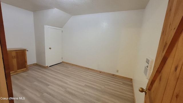 bonus room featuring light hardwood / wood-style floors and vaulted ceiling