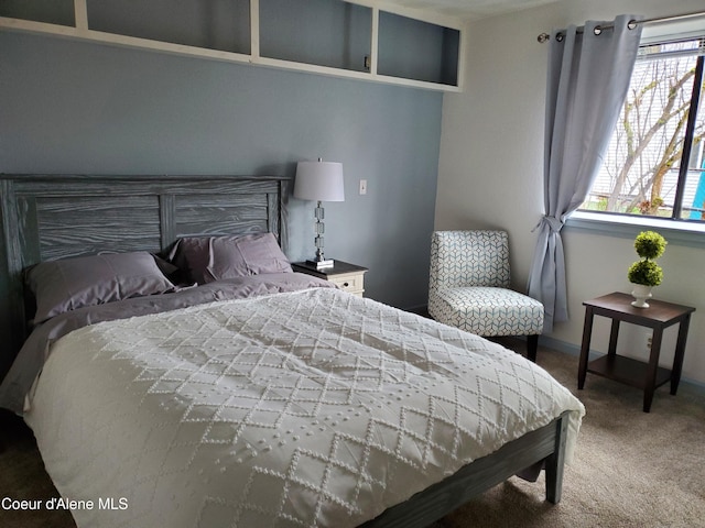 bedroom with carpet and multiple windows