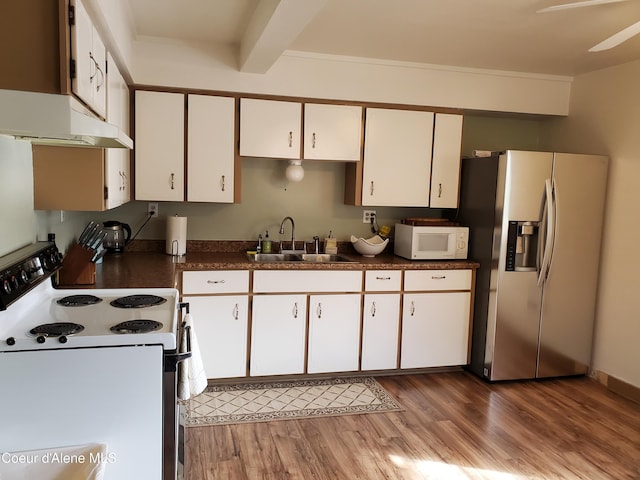 kitchen featuring white appliances, sink, beam ceiling, light hardwood / wood-style floors, and white cabinetry