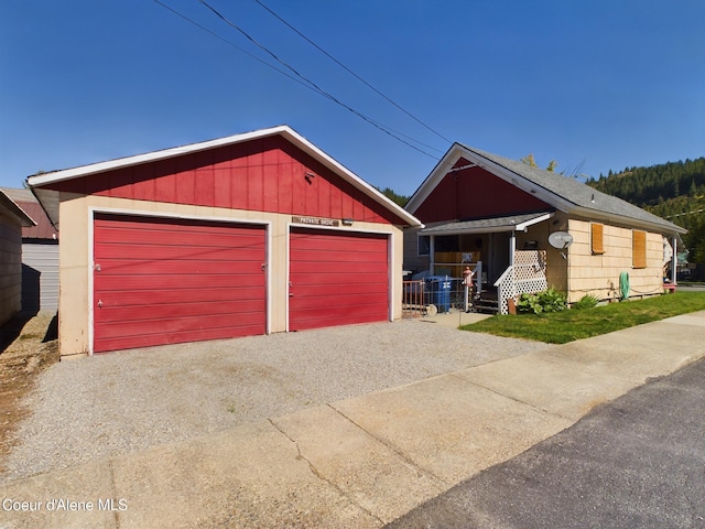 view of front of home featuring a garage and an outdoor structure