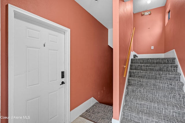 stairway featuring tile patterned flooring