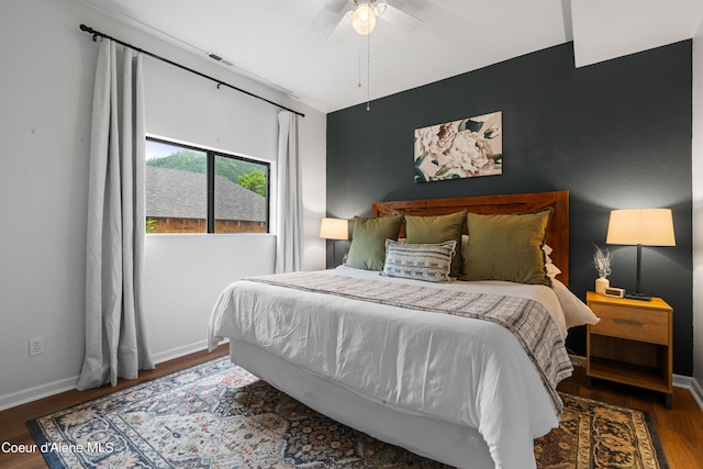 bedroom with ceiling fan and dark hardwood / wood-style flooring