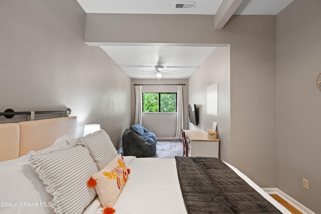 bedroom with beamed ceiling and ceiling fan