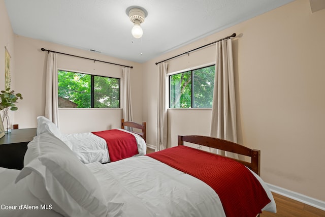 bedroom with hardwood / wood-style flooring and ceiling fan