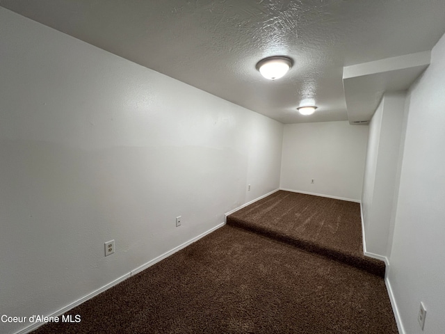 basement with carpet floors and a textured ceiling