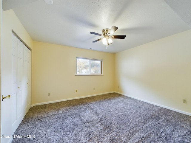 unfurnished bedroom with carpet flooring, ceiling fan, and a textured ceiling