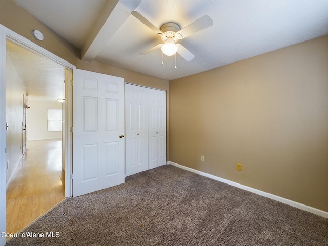 unfurnished bedroom with carpet flooring, ceiling fan, and a closet