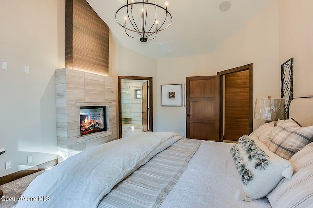 L3B10 N Walden Loop, Rathdrum, ID 83858 - bedroom with a notable chandelier, a fireplace, ensuite bathroom, and high vaulted ceiling