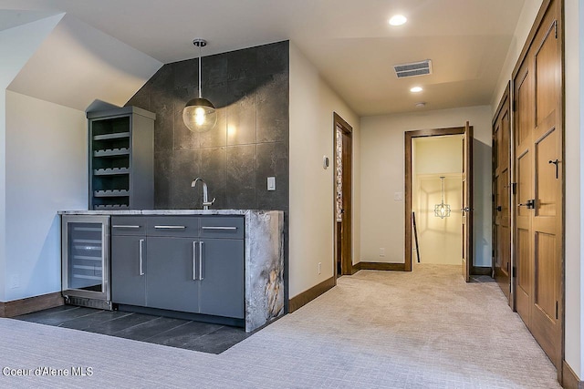 L3B10 N Walden Loop, Rathdrum, ID 83858 - bar with wine cooler, sink, decorative light fixtures, dark colored carpet, and vaulted ceiling