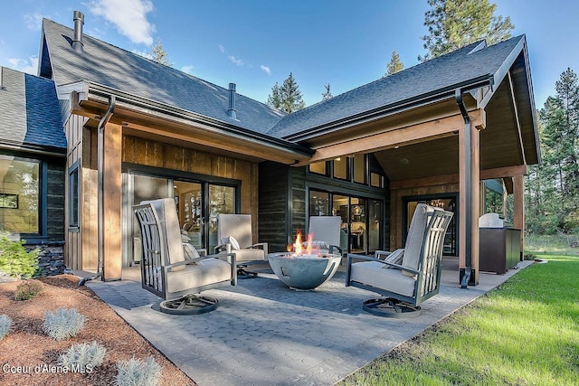 L3B10 N Walden Loop, Rathdrum, ID 83858 - rear view of house featuring a patio and an outdoor fire pit