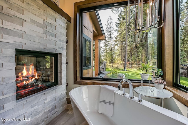 L3B10 N Walden Loop, Rathdrum, ID 83858 - bathroom featuring a stone fireplace, a wealth of natural light, and a bathing tub