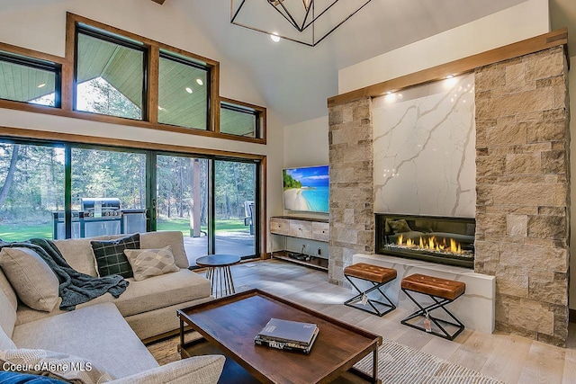 L3B10 N Walden Loop, Rathdrum, ID 83858 - living room with high vaulted ceiling, light wood-type flooring, and a fireplace