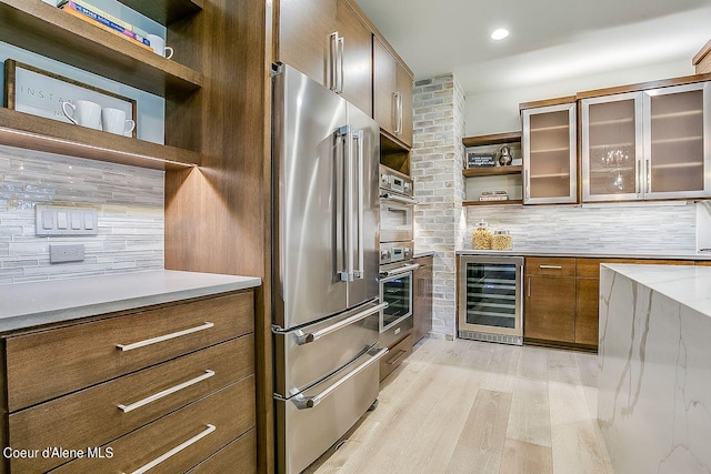 L3B10 N Walden Loop, Rathdrum, ID 83858 - kitchen featuring decorative backsplash, wine cooler, light hardwood / wood-style floors, and high end fridge