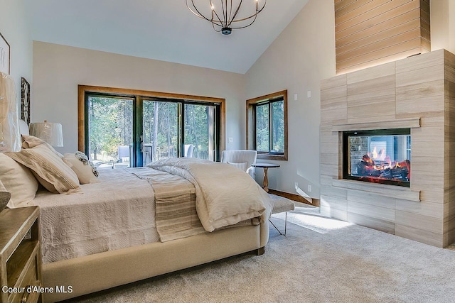 L3B10 N Walden Loop, Rathdrum, ID 83858 - bedroom featuring carpet flooring, a tiled fireplace, high vaulted ceiling, an inviting chandelier, and access to exterior