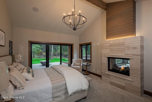 L3B10 N Walden Loop, Rathdrum, ID 83858 - carpeted bedroom featuring access to exterior, a notable chandelier, beam ceiling, a fireplace, and high vaulted ceiling