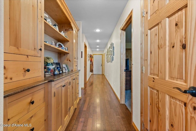 corridor with dark hardwood / wood-style flooring