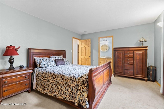 carpeted bedroom with connected bathroom