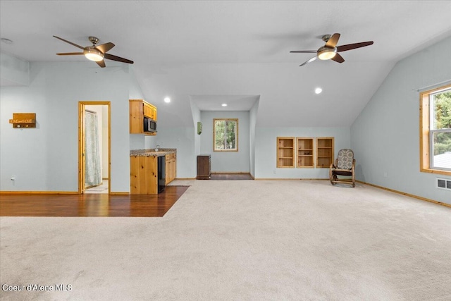 unfurnished living room with lofted ceiling, ceiling fan, and wood-type flooring