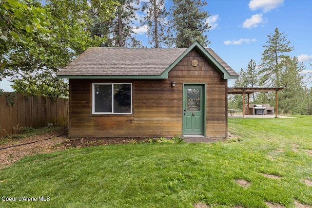 view of front facade featuring an outbuilding and a front yard