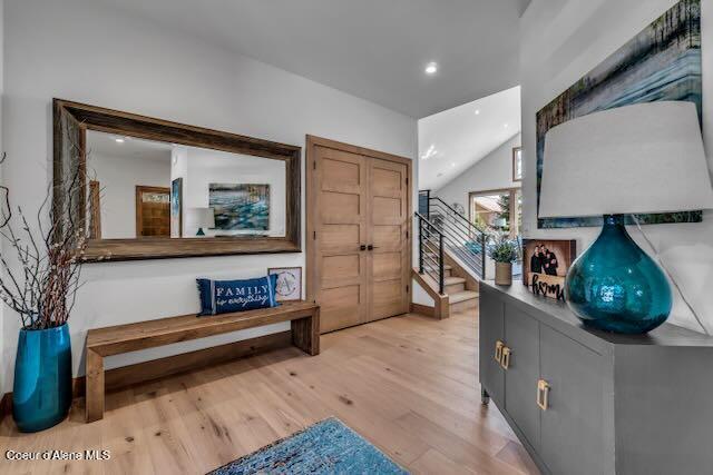 interior space with lofted ceiling and light hardwood / wood-style flooring