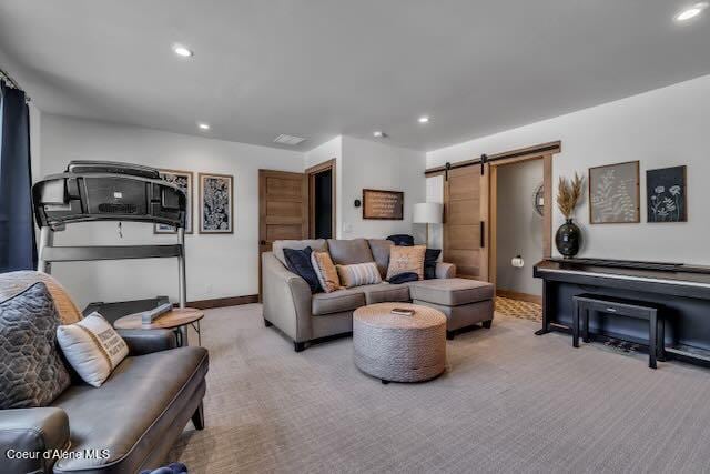 living room with carpet flooring and a barn door