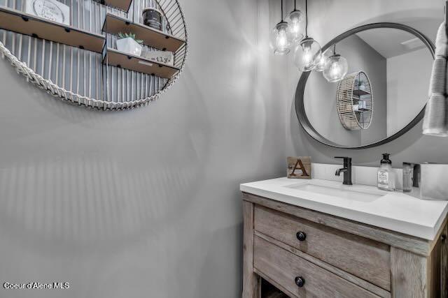 bathroom with vanity and a chandelier