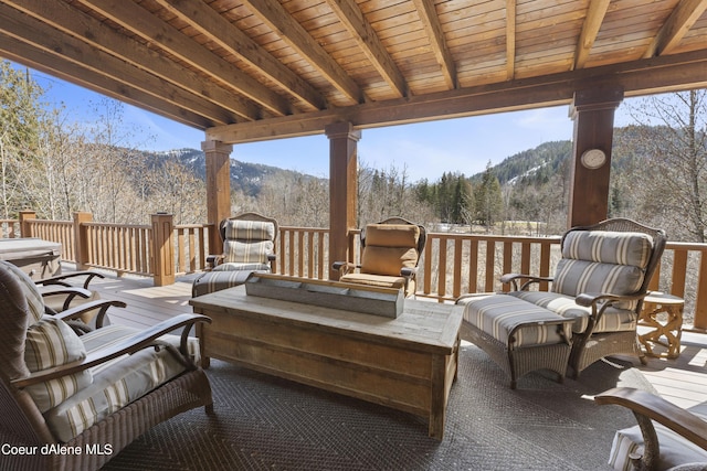 exterior space featuring a view of trees and a deck with mountain view
