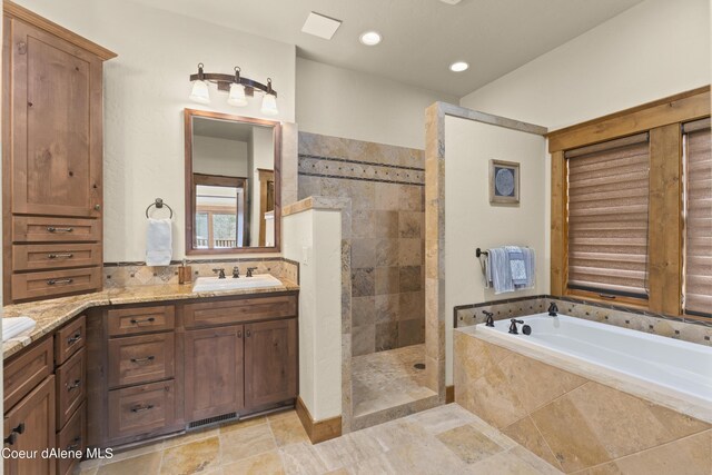 bathroom with vanity, recessed lighting, walk in shower, a garden tub, and visible vents