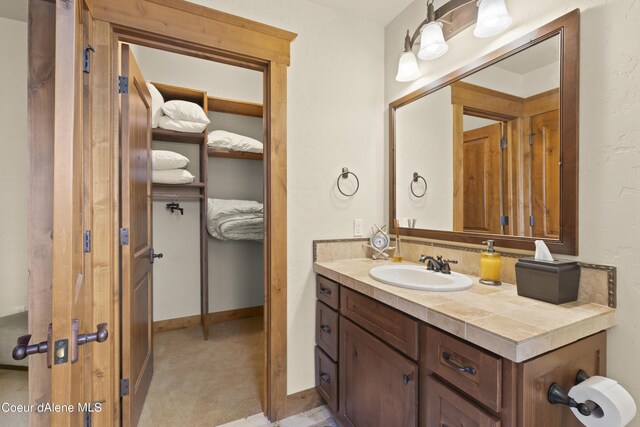 bathroom featuring baseboards and vanity