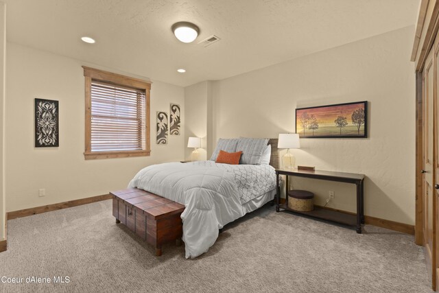 carpeted bedroom featuring baseboards, visible vents, and recessed lighting