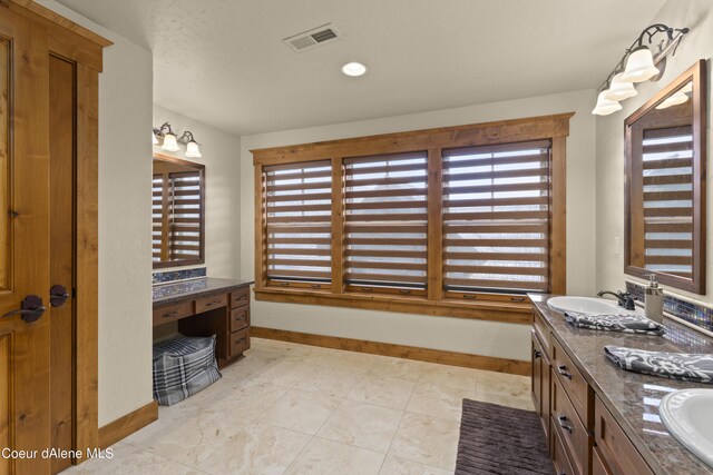 full bathroom featuring baseboards, double vanity, a wealth of natural light, and visible vents