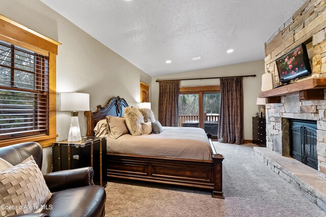 bedroom with access to exterior, carpet flooring, a fireplace, a textured ceiling, and recessed lighting