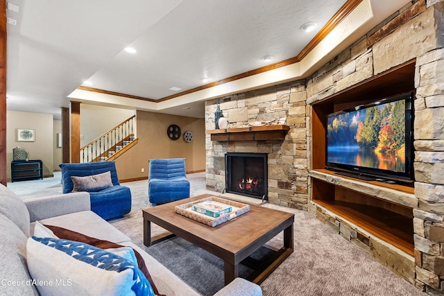 living room featuring carpet floors, stairs, crown molding, and a stone fireplace