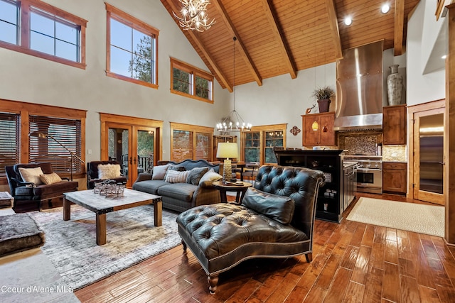 living area with french doors, wooden ceiling, dark wood-type flooring, and a chandelier