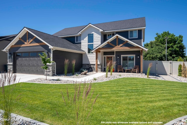 craftsman inspired home featuring a front yard and a garage