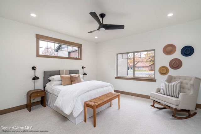 bedroom with ceiling fan, light carpet, and multiple windows