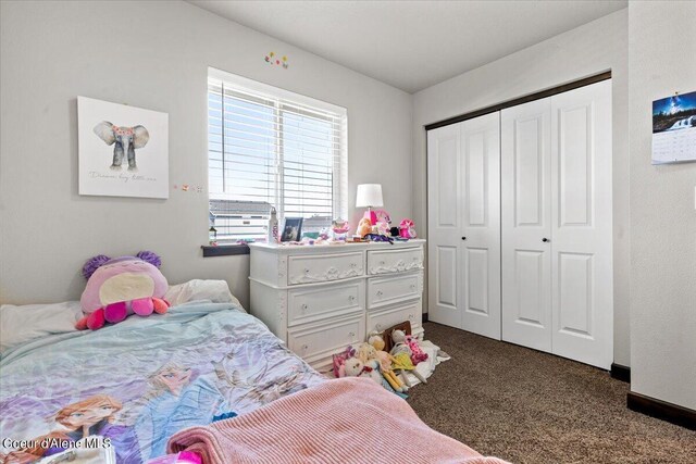 bedroom with dark colored carpet and a closet