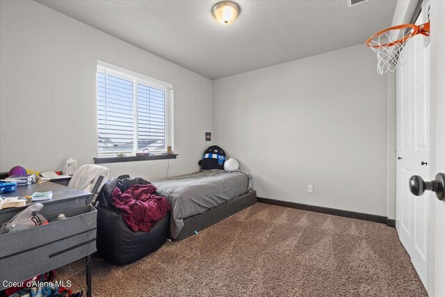 carpeted bedroom featuring a textured ceiling