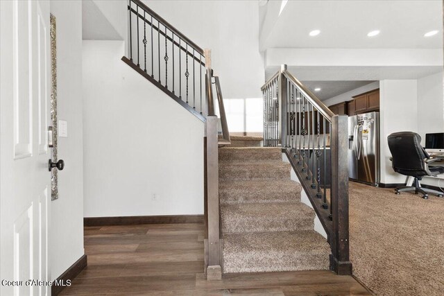 stairs with hardwood / wood-style flooring