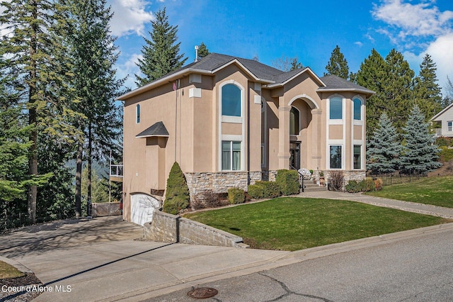view of front of home with stone siding, concrete driveway, stucco siding, and a front lawn
