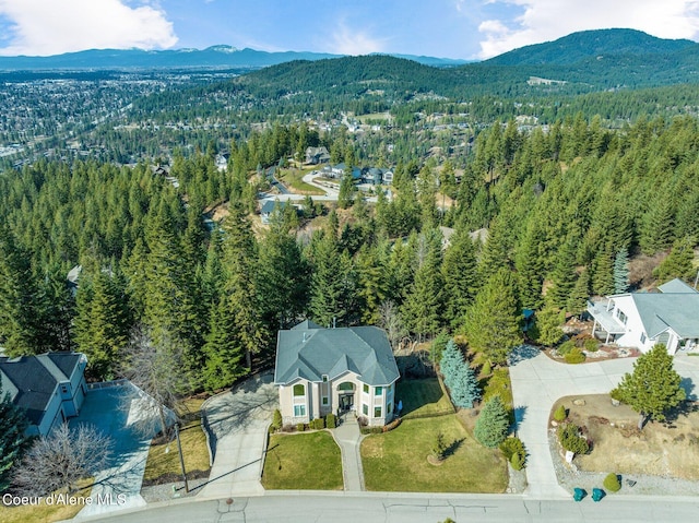 aerial view featuring a mountain view and a forest view