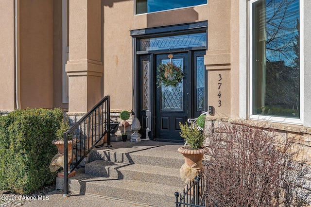 doorway to property with stucco siding