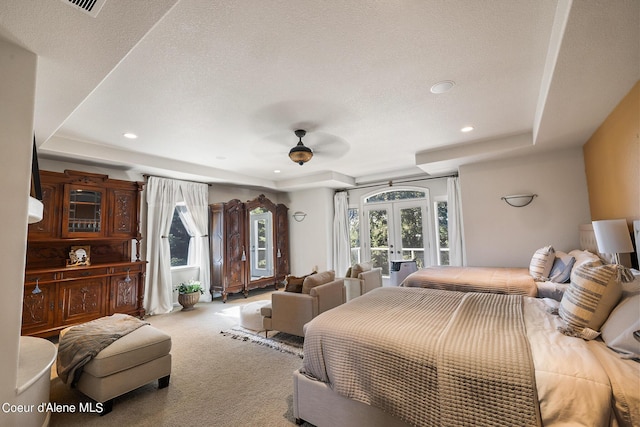 carpeted bedroom featuring french doors, a raised ceiling, access to outside, and a textured ceiling
