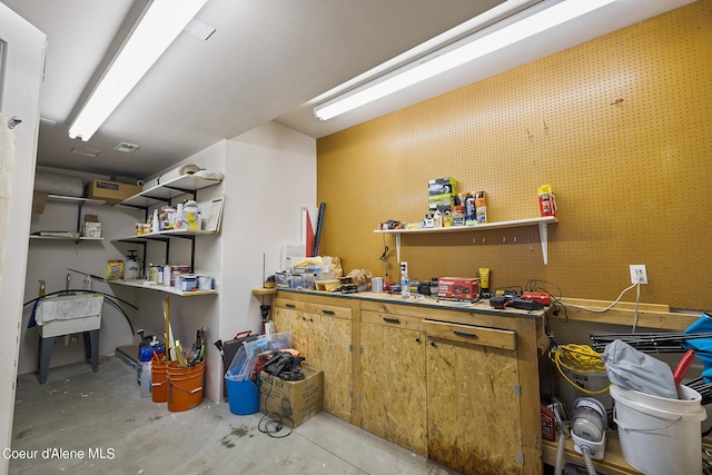 misc room featuring unfinished concrete floors and a workshop area