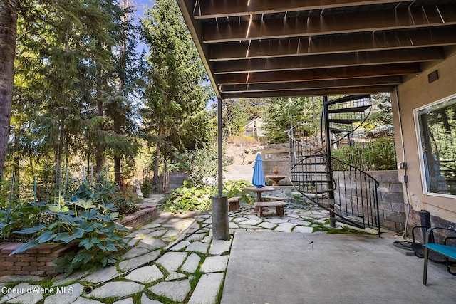 view of patio / terrace with stairs and fence