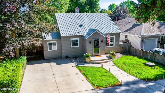 view of front of home with a front yard and a garage