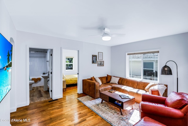 living room with ceiling fan and hardwood / wood-style floors