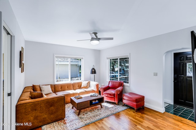 living room featuring wood-type flooring and ceiling fan