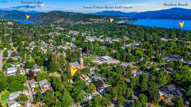 birds eye view of property featuring a water and mountain view