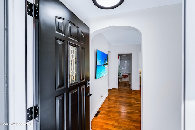 hallway with dark hardwood / wood-style flooring